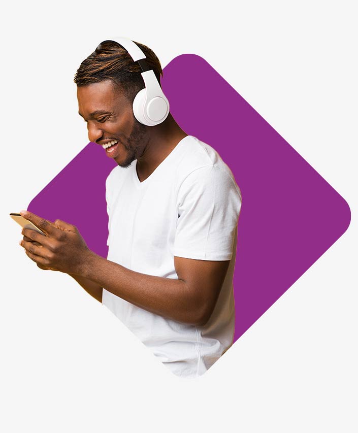 Young man with headphones and smartphone. He is happy about the Power Apps.